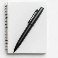 Notepad and black pen set on a clean white background ready for writing notes or ideas at any time photo