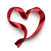 Red satin ribbon shaped as a heart on a plain background evoking love and affection for various occasions photo