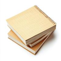 Notebooks stacked on a white surface displaying blank pages for creative ideas and sketching photo