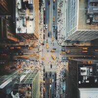 Busy urban intersection filled with yellow taxis and pedestrians in a bustling city environment photo