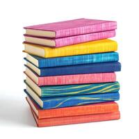 Colorful stacked books showcasing vibrant covers in a bright arrangement on a white background photo