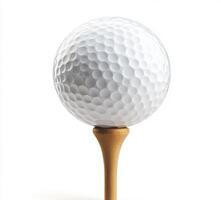 Golf ball resting on a wooden tee ready for a swing on a sunny day at the golf course photo