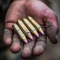 Soldier holds several shiny bullets in hand, showcasing the tools of warfare during a military operation photo