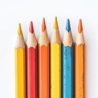 Colorful collection of sharpened pencils arranged neatly on a white surface for art and creativity photo