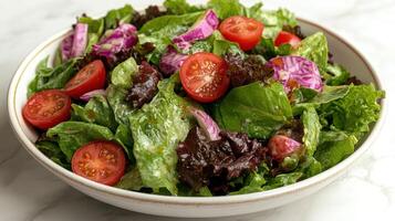 Crisp greens and juicy tomatoes make a refreshing salad, ideal for lunch or dinner photo