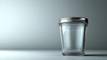 A clear glass jar on a smooth surface showcases minimalism and subtle reflections photo
