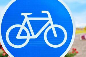 A traffic sign displaying a white bicycle on a blue background is a symbol for bicycle lanes. The azure color pops with the font style, reminding motor vehicles to watch out for cyclists photo