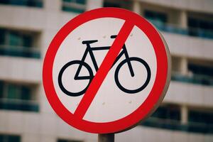 A red and white traffic sign with bold font that prohibits bicycles from entering. The sign specifically states No bicycles allowed to prevent any twowheeled vehicles from using the road photo
