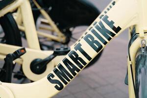 A detailed shot of a sleek bicycle parked on a sidewalk, showcasing its advanced features like a crankset, rim, and bicycle tire photo
