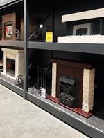 Kyiv, Ukraine - January 03, 2025 Indoor fireplace display showcasing various design models and details in a store setting photo