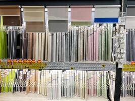 Kyiv, Ukraine - January 03, 2025 Assorted Window Blinds and Shades Displayed on a Store Shelf with Discounts photo
