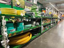 Kyiv, Ukraine - January 03, 2025 Row of colorful garden hoses displayed in a hardware store aisle photo