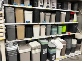 Kyiv, Ukraine - January 03, 2025 Selection of trash bins on store shelves of various colors and sizes photo