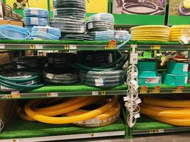 Kyiv, Ukraine - January 03, 2025 Different types of garden hoses and accessories displayed on a store shelf photo