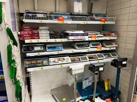 Kyiv, Ukraine - January 03, 2025 Array of digital and mechanical scales displayed on shelves in a store photo