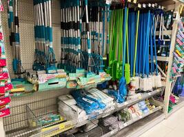 Kyiv, Ukraine - January 03, 2025 Various Cleaning Tools Displayed on Shelves in a Store Aisle Setting photo