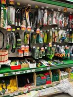 Kyiv, Ukraine - January 03, 2025 Various gardening tools organized on a store shelf with colorful packaging photo
