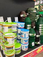 Kyiv, Ukraine - January 03, 2025 Store Shelf Display of Paint Buckets and Garden Accessories photo