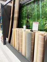 Kyiv, Ukraine - January 03, 2025 Various rolls of bamboo-style wallpaper in a home improvement store photo
