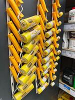 Kyiv, Ukraine - January 03, 2025 Colorful display of paint rollers arranged on store shelf photo