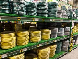 Kyiv, Ukraine - January 03, 2025 Stacked rows of garden hoses displayed on store shelves for sale photo