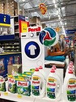 Kyiv, Ukraine - January 03, 2025 Shelf Display of Detergent Products in a Supermarket Setting photo