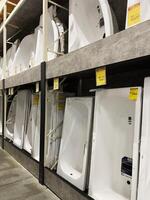 Kyiv, Ukraine - January 03, 2025 Various bathtubs displayed in a modern home improvement store showroom setting photo