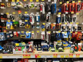 Kyiv, Ukraine - January 03, 2025 Various flashlights, lanterns, and lighting products displayed on a store shelf photo