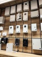 Kyiv, Ukraine - January 03, 2025 Display of electrical equipment and meter boxes mounted on a wooden wall photo