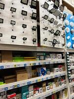 Kyiv, Ukraine - January 03, 2025 Selection of LED floodlights and lighting solutions displayed on a retail shelf photo