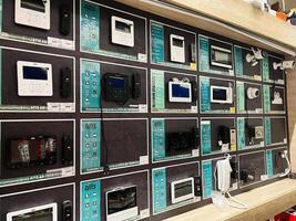 Kyiv, Ukraine - January 03, 2025 Wall display of electronic security devices and intercom equipment in a store photo