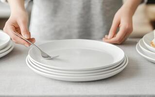 Setting festive family dinner with white plates and silverware photo