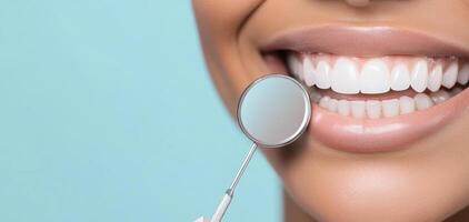 Close up smile showing healthy teeth, holding dental mirror reflecting light photo