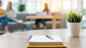 cozy counseling scene featuring notebook and pen on table, with diverse individuals in background engaged in conversation photo