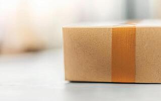 close up of cardboard box with brown tape seal, conveying sense of anticipation and delivery photo