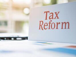 Tax reform document on table with colorful charts and graphs, showcasing financial data and analysis photo