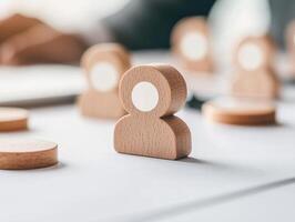 Wooden figures representing employees on desk, symbolizing teamwork and collaboration photo