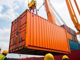 High tech crane system loading orange container onto ship at port photo