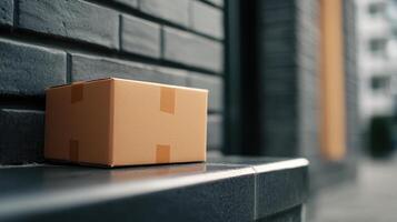 shipping box placed on doorstep, ready for delivery, against brick wall photo