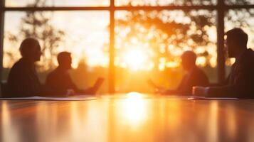 Business meeting at sunset with silhouettes of professionals discussing photo