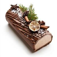 Festive yule log cake with chocolate icing, decorated with pine, spices, and dried lemon. Perfect for winter celebrations photo