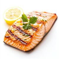 Grilled salmon fillet garnished with herbs and lemon slice, delicious photo