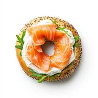 Fresh bagel topped with cream cheese, smoked salmon, and arugula photo