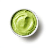 Creamy avocado dressing in white bowl, smooth and vibrant green, perfect for salads photo