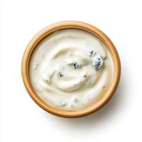 Creamy blue cheese dressing in wooden bowl, perfect for salads and dips photo