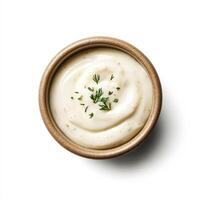 Creamy garlic aioli in bowl, garnished with fresh herbs, perfect for dipping photo