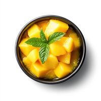 Fresh mango chunks in bowl with mint leaves, bright yellow color, perfect for summer photo