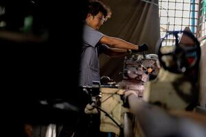 A detailed view of metal lathe operation reveals a steel column rolling smoothly through the machining process. photo