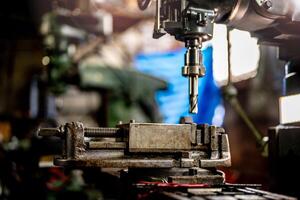 Sparks fly as a lathe grinder machine works on refining the internal surface of a steel column. photo