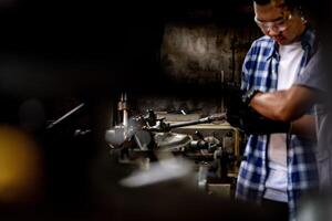 A worker uses a drilling machine to create precise holes in metal at a production site. photo